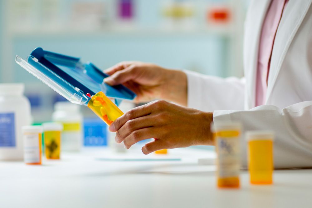 Image of pharmacist filling drug prescription